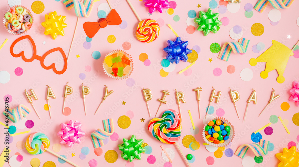 Horizontal panoramic banner with lollypops, confetti, bows on pink background Horizontal panoramic banner with lollypops, confetti, bows on pink background