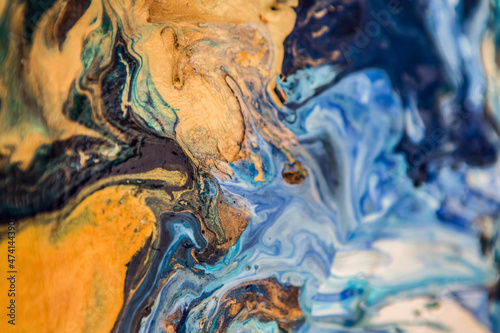 Beautiful fluid abstract paint background. Blue acrylic texture.