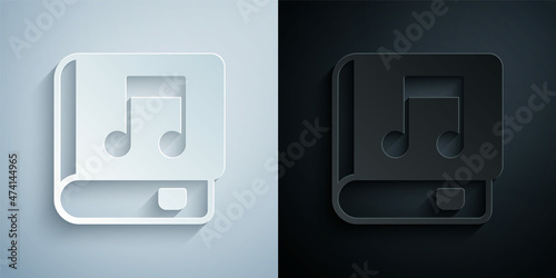 Paper cut Audio book icon isolated on grey and black background. Musical note with book. Audio guide sign. Online learning concept. Paper art style. Vector