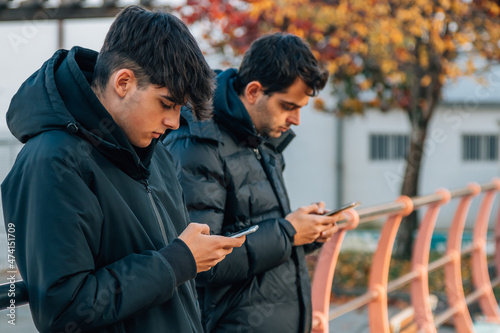 young people with mobile phones on the street
