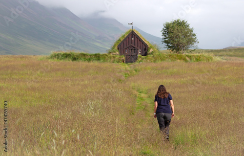 Woman walking towards the Grafarkirkja, a small chapel in Iceland