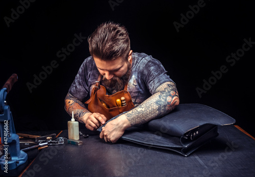 Leather workman produces a good product at his studio photo