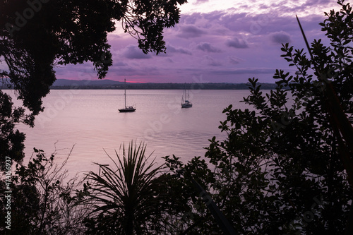 Yachts at anchor at sunset.