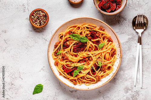 Pasta with bolognese sauce and sun-dried tomatoes photo