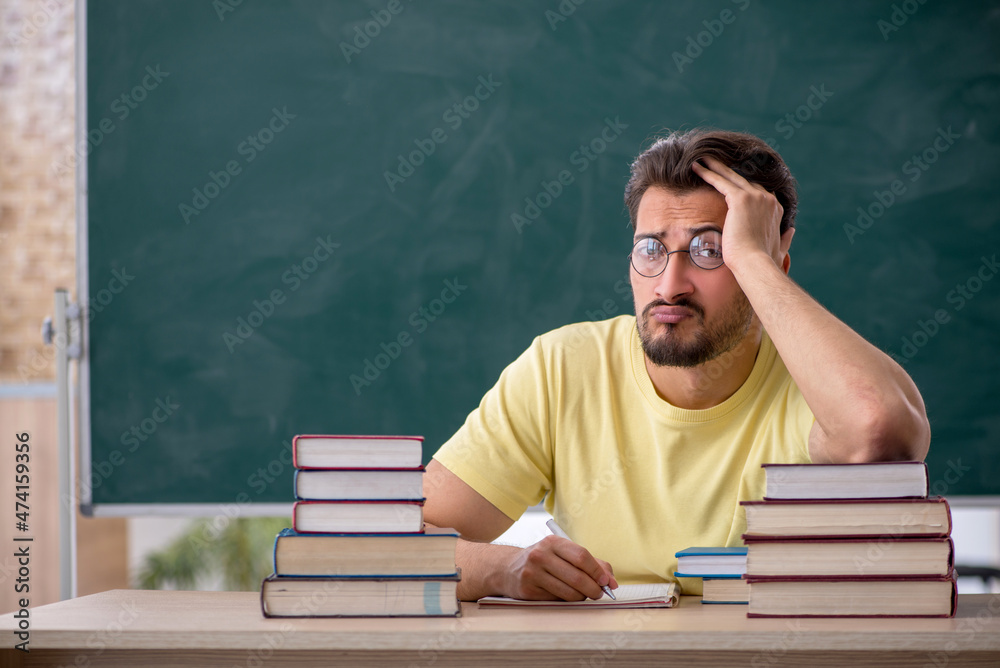 Young male student preparing for exams in the classroom Young male student preparing for exams in the classroom