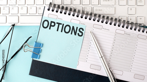 OPTIONS text on blue sticker on planning and keyboard,blue background photo