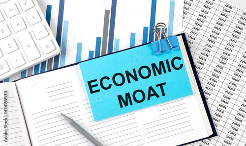 ECONOMIC MOAT text on blue sticker on the chart background near calculator