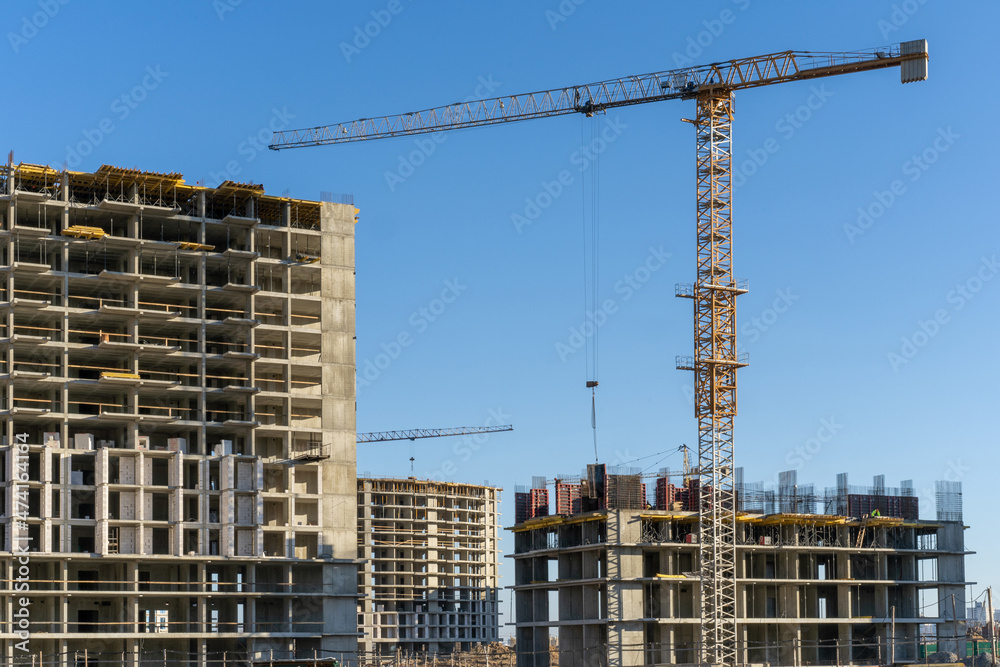 Photo of the construction site and building of high buildings and cranes in the city. Constructional concept Photo of the construction site and building of high buildings and cranes in the city. Constructional concept