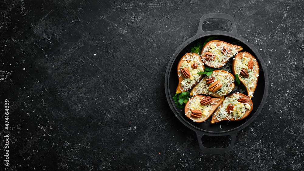 Baked pears with blue cheese and nuts. In a frying pan. Rustic style. Flat Lay.