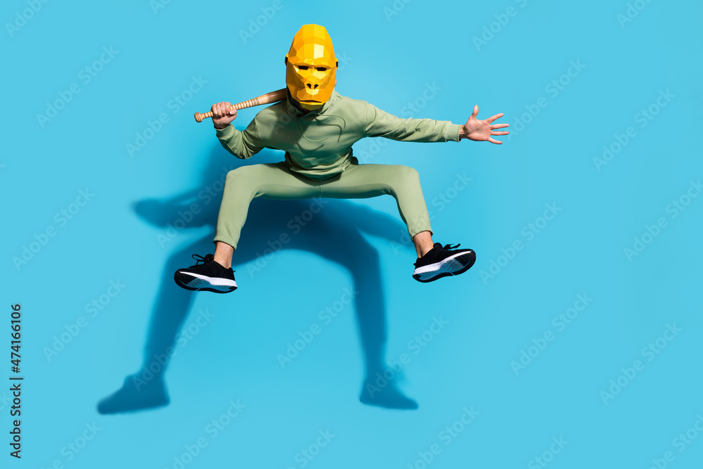 Photo of crazy protester guy jump prepare defend freedom wear gorilla mask isolated blue color background