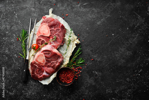 Osso buco Veal steak with rosemary and spices. On a black background. Top view. photo