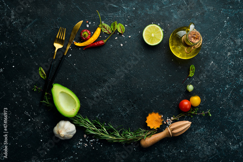 Black stone background with vegetables and spices.Top view. Rustic style.