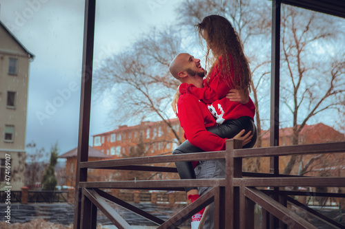 beautiful couple hugs on a balcony winter time. Christmas Mood