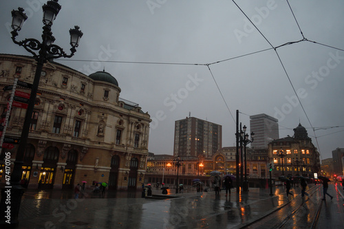 Arriaga Theater in Bilbao on a rainy evening next to the tram