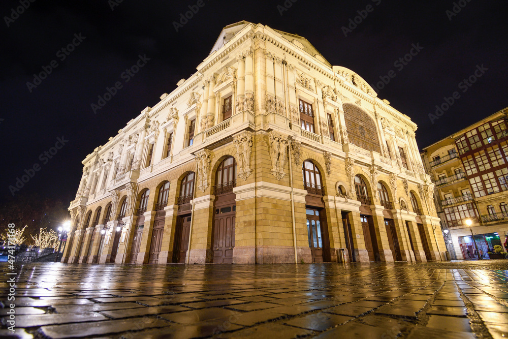 Close-up of the Arriaga theater at night and with rain