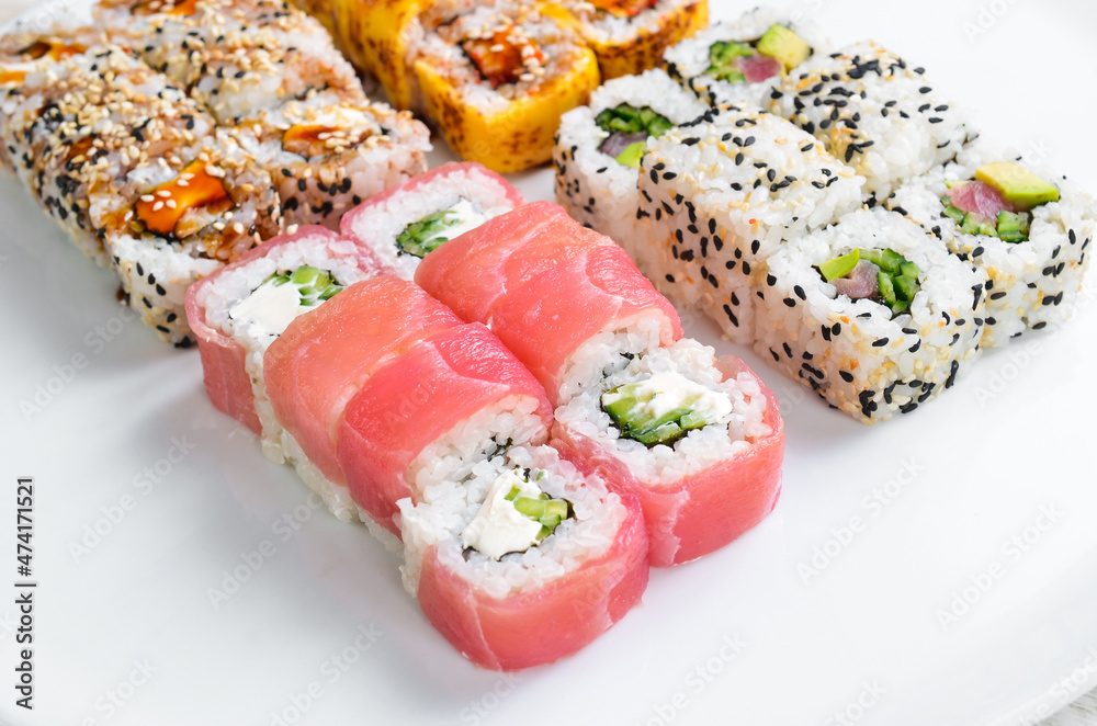 Set: sushi rolls with eel, sesame, avocado and fish. Japanese food. Top view. On a white background. Set: sushi rolls with eel, sesame, avocado and fish. Japanese food. Top view. On a white background.