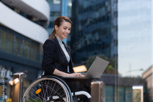 Disabled businesswoman in a wheelchair working outside