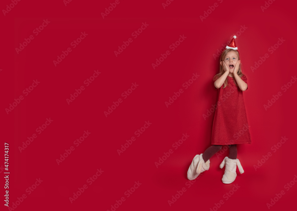 girl in Christmas costume on background of red banner copying space for new year girl in Christmas costume on background of red banner copying space for new year
