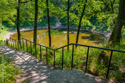 Stairs leading to the lake. Round lake in Kaali meteorite crater. Estonian island of Saaremaa. photo