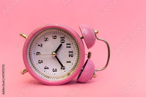 The alarm clock is lying and tired of having to get up early. A lot of work ahead, to learn all the lessons and homework. Time to wake up and get work done. Depression alarm clock. 