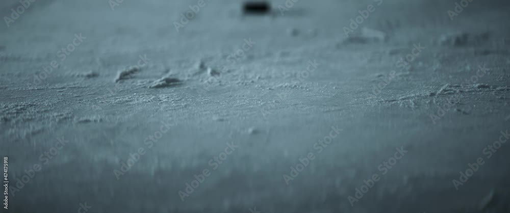 CU View of a hockey puck falling on ice in slow motion. Shot with 2x anamorphic lens CU View of a hockey puck falling on ice in slow motion. Shot with 2x anamorphic lens