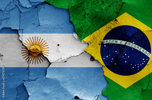 flags of Argentina and Brazil painted on cracked wall