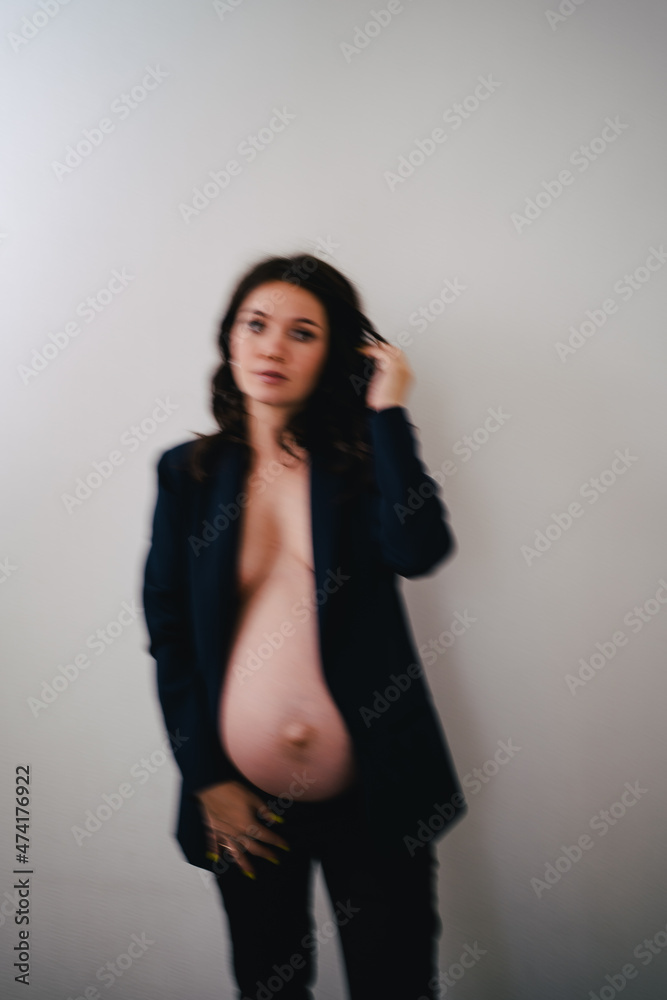 defocus beautiful pregnant woman in a black jacket with bare breasts and a belly defocus beautiful pregnant woman in a black jacket with bare breasts and a belly