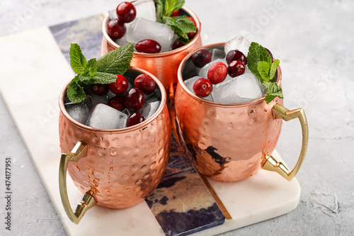 Photography Traditional american alcoholic beverage moscow mule in copper mugs with cranberr