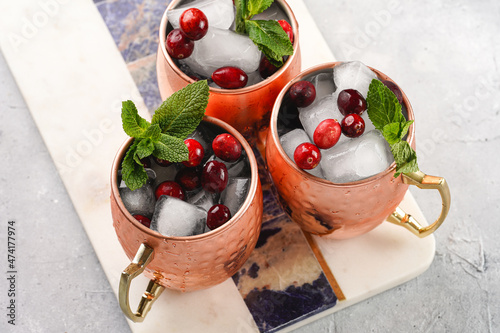 Photography Traditional american alcoholic beverage moscow mule in copper mugs with cranberr