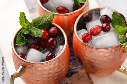 Photography Traditional american alcoholic beverage moscow mule in copper mugs with cranberr