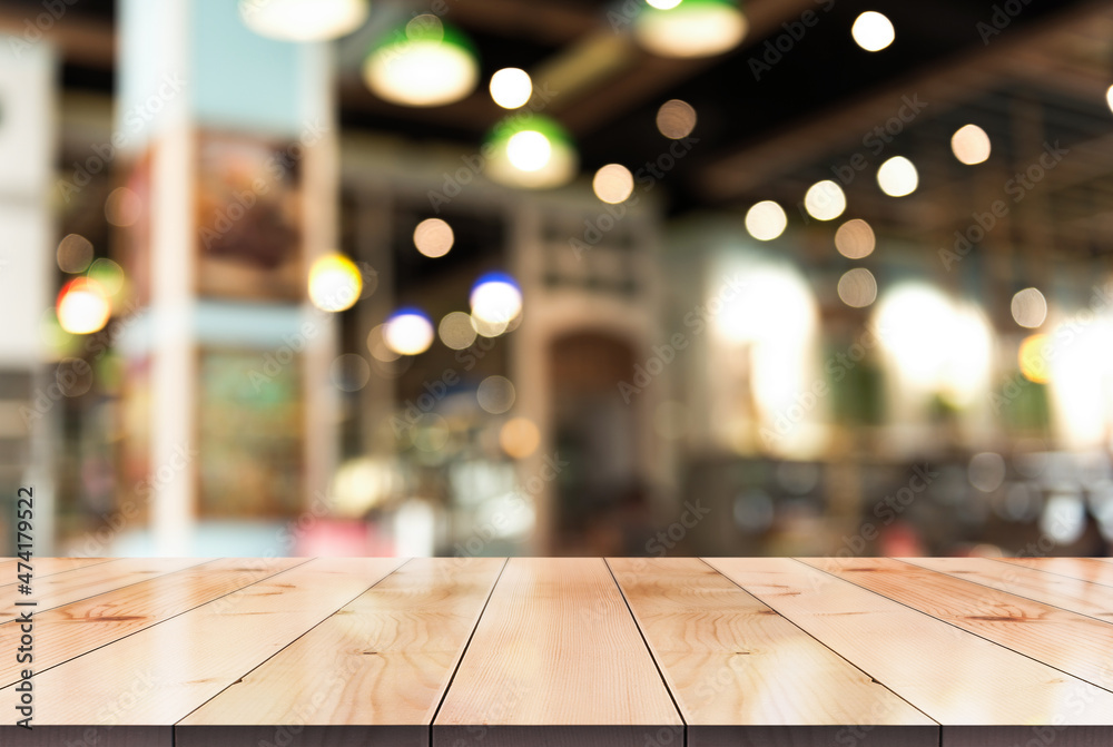 Empty wooden table top with lights bokeh on blur restaurant background. Empty wooden table top with lights bokeh on blur restaurant background.