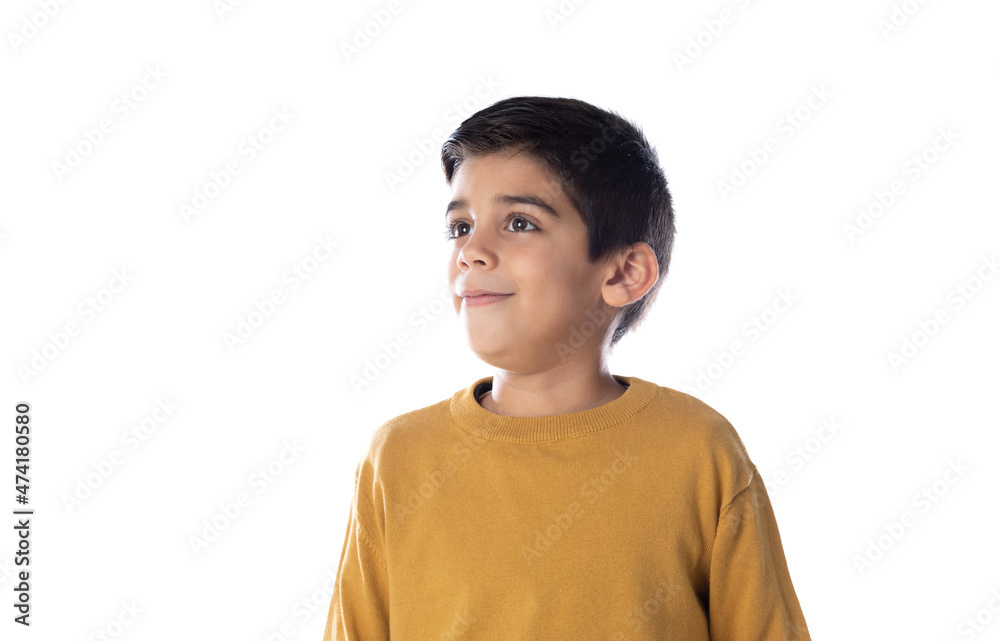 Pensive cute Spanish child with yellow t-shirt Pensive cute Spanish child with yellow t-shirt