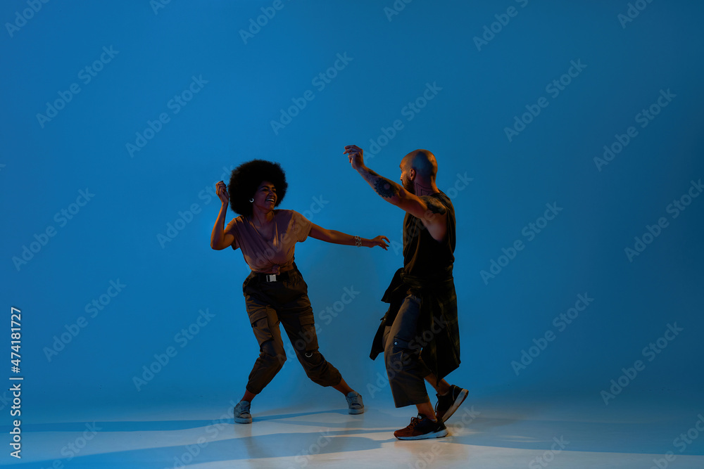 Multiracial guy and girl dancing hip hop dance