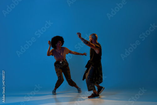Multiracial guy and girl dancing hip hop dance
