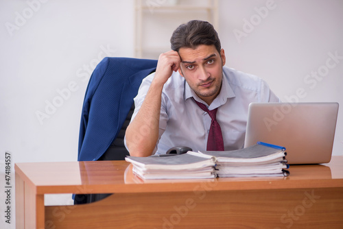 Young businessman and too much work in the office © Elnur