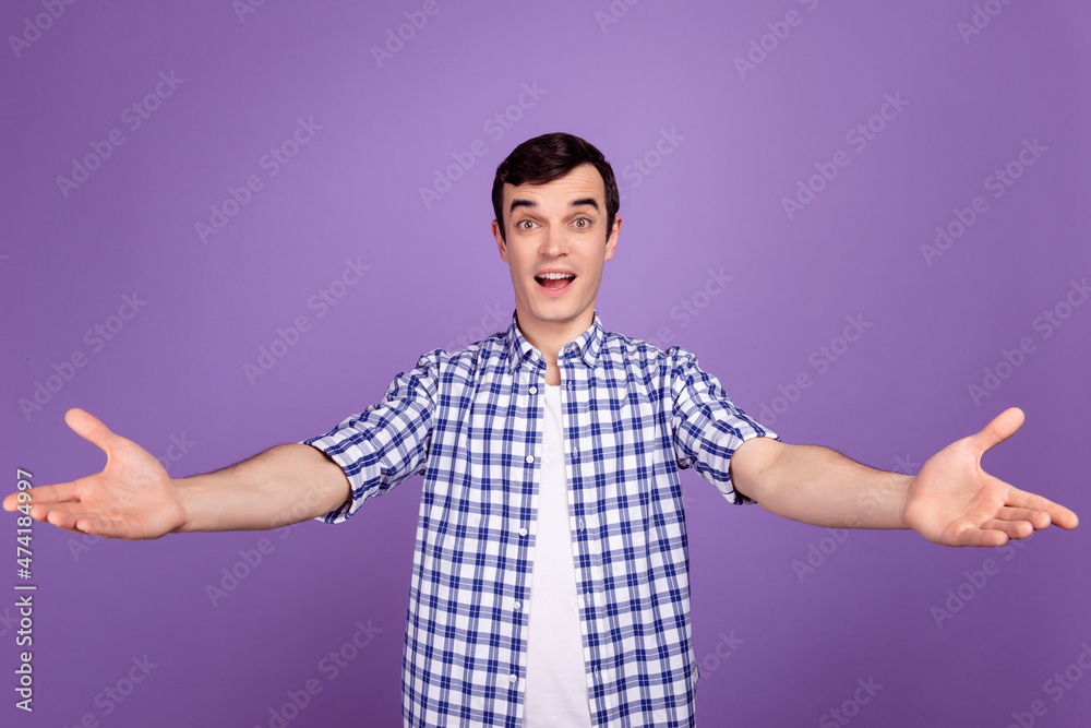 Photo of young cheerful man good mood open arms welcome invite isolated over violet color background Photo of young cheerful man good mood open arms welcome invite isolated over violet color background