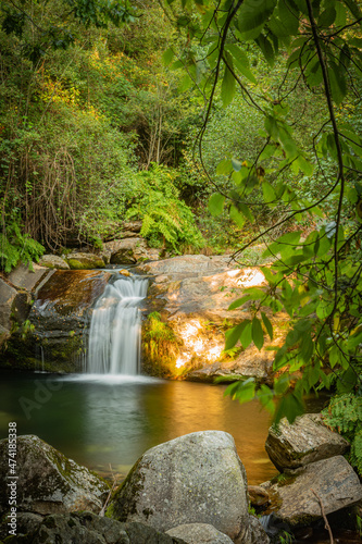 Beautiful water stream in Poço da Cilha waterfall, Manhouce, Sao Pedro do Sul, Portugal. Long exposure smooth effect. Mountain forest landscape.