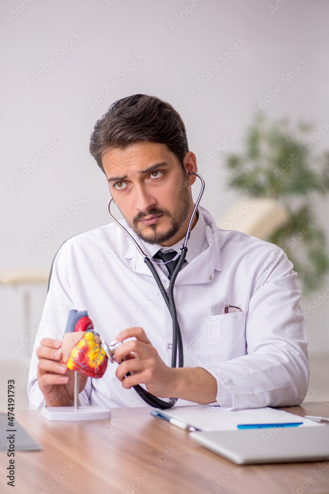 Young male doctor cardiologist working in the clinic Young male doctor cardiologist working in the clinic