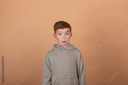 Teen boy portrait teenager isolated on brown background. emotions on face. feelings and facial expression concept. advertisement. copy free space for text.