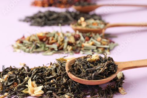 Concept of cooking tea with different types of tea on purple background