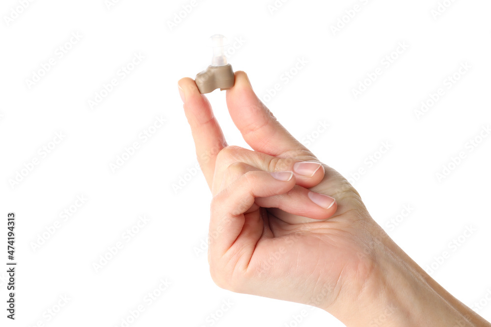 Hand holds hearing aid, isolated on white background Hand holds hearing aid, isolated on white background