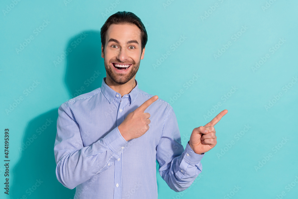 Photo of surprised crazy funny guy indicate finger empty space solution wear violet shirt isolated teal color background Photo of surprised crazy funny guy indicate finger empty space solution wear violet shirt isolated teal color background
