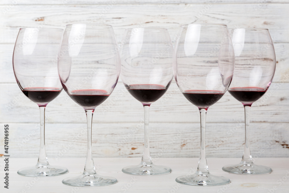 Many glasses of red wine at wine tasting. Concept of red wine on colored background. Top view, flat lay design Many glasses of red wine at wine tasting. Concept of red wine on colored background. Top view, flat lay design