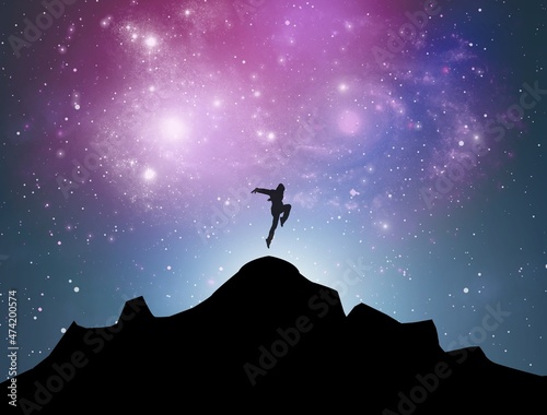 Milky Way and man on the mountain peak at starry night. Silhouette of alone guy