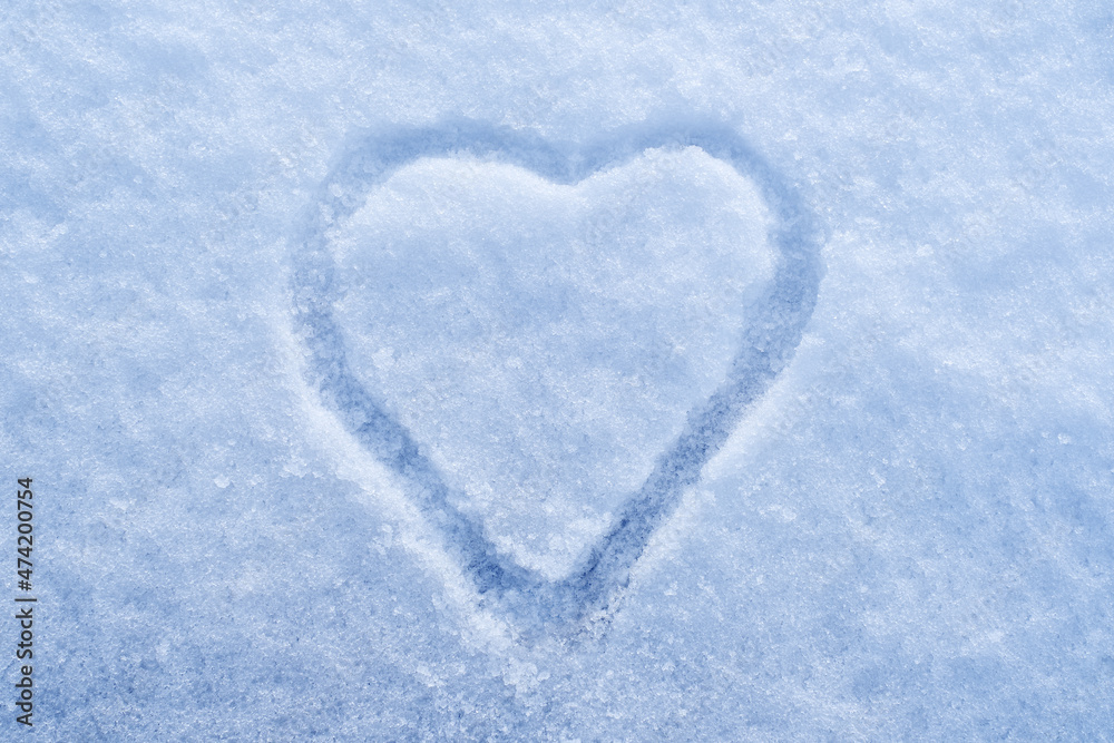 Heart shape on snow, hand drawn heart. Winter love concept