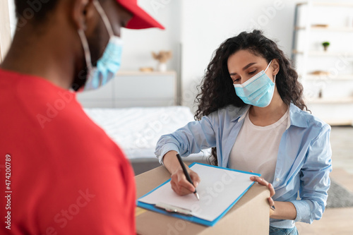 Customer In Face Mask Receiving Order Signing Paper Form