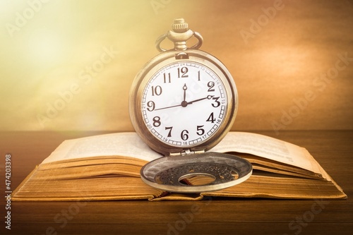 Vintage pocket watch and books. Vintage background Concept of time history.