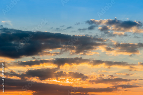Fototapeta Naklejka Na Ścianę i Meble -  Nature background of evenging sky . Gradation of the blue sky to the four oranges with dark clouds.