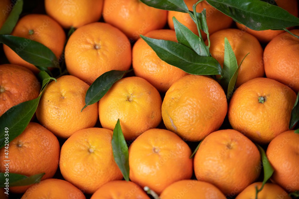 background of natural fresh tangerine with green leaves background of natural fresh tangerine with green leaves