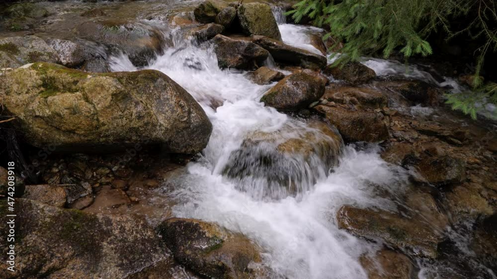Static shot of crystal clear mountain stream rocky waters flowing rapidly into the forest in 4K. Static shot of crystal clear mountain stream rocky waters flowing rapidly into the forest in 4K.